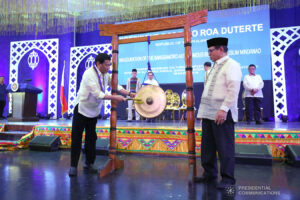 President Rodrigo Duterte rings the agong with interim Chief Minister Murad Ebrahim nearby as part of the inauguration of the Bangsamoro region on March 29, 2019. Photo Source: ROBINSON NIÑAL JR./PRESIDENTIAL PHOTO